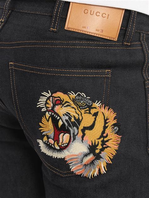 black gucci jeans with tiger embroidery